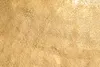 A close-up, textured view of a gold surface. Produktbild-Vorschau