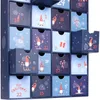 A close-up view of a blue advent calendar with numbered drawers, decorated with gnome and Christmas motifs. Náhľad obrázku produktu