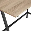 A close-up shot of a wooden desk with black metal legs. Náhled obrázku produktu