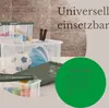 Several clear plastic storage boxes of different sizes are stacked and arranged, containing various items like a soccer ball, a helmet, and tennis rackets. A green lid is also visible. The background features a brick-like pattern and a soft, neutral gradie Anteprima dell’immagine prodotto