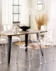A dining room setting with a wooden table and transparent chairs. Produktbild-Vorschau