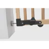 Close-up of a wooden baby gate hinge mechanism attached to a wall. Podgląd zdjęcia produktu