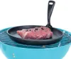 A raw steak seasoned with peppercorns sits in a cast iron skillet on top of a blue grill. Náhled obrázku produktu