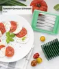 A table setting with a caprese salad and a tomato slicer. Voir les images du produit