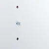 A close-up of a white surface with two pre-drilled holes and a metal fitting inserted into one of them. Produktbild-Vorschau
