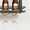 A close-up view of a wine rack with two bottles of liquor and two wine glasses hanging from it. Náhled obrázku produktu