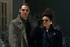 A man and a woman stand outside in what appears to be a snowy environment, both wearing sunglasses and coats. Podgląd zdjęcia produktu