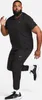 A man wearing Nike athletic wear is captured mid-stride against a plain white background. Podgląd zdjęcia produktu