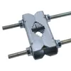 A close-up studio shot of a metal clamp with threaded bolts. Voir les images du produit