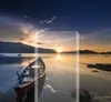 A clear screen protector is placed over a scenic image of a sunset over a lake with a boat. Náhľad obrázku produktu