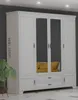 A white wardrobe with mirrored doors and yellow pillows visible inside, set against a gray wall. Produktbild-Vorschau