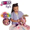 A young girl is styling a doll's hair, surrounded by accessories and promotional graphics. Podgląd zdjęcia produktu