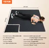 A woman is doing a plank exercise on a black interlocking floor mat with white speckles. A separate set of interlocking mats is shown in the foreground. Produktbild-Vorschau