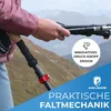 A person is holding a hiking pole in a mountainous environment. Voir les images du produit