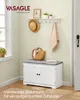 An entryway scene featuring a white shoe bench with a gray cushion, a straw bag, and a towel hanging on a wall-mounted rack. Produktbild-Vorschau