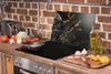 A kitchen counter with a stovetop, cutting board, and various food items. Náhľad obrázku produktu