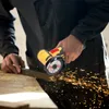 A person is using a mini angle grinder to cut a metal bar, with sparks flying. Náhľad obrázku produktu