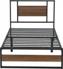 A black metal bed frame with a walnut-effect headboard and footboard. Produktbild-Vorschau