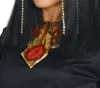 Close-up of a person wearing a black garment and Egyptian-style jewelry. Produktbild-Vorschau