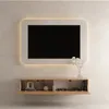 A modern TV board mounted on a wall, with a TV above it. Produktbild-Vorschau