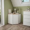 A corner of a room with a white corner cabinet and a chest of drawers, decorated with vases and books. Anteprima dell’immagine prodotto