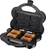 An open dog treat maker with four bone-shaped dog treats on the bottom plate. Produktbild-Vorschau