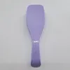 A top-down view of a purple hairbrush against a white background. Anteprima dell’immagine prodotto