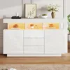 A modern white sideboard with LED lighting, decorated with a framed picture, vases, and books. Produktbild-Vorschau