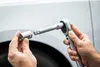 Hands holding a socket wrench and a socket, preparing to attach them. Anteprima dell’immagine prodotto