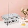 A chafing dish is set on a table with a pink background and some flowers. Podgląd zdjęcia produktu