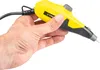 A hand holding a yellow and black engraving tool. Produktbild-Vorschau