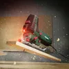 A jigsaw is cutting a wooden plank, with sawdust flying. Produktbild-Vorschau