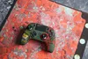 A green Nacon Revolution Unlimited Pro controller is placed on a map with an orange and red color scheme. Produktbild-Vorschau