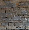 A close-up, full-frame shot of a stone wall. Produktbild-Vorschau