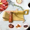 A wooden slicer for sausage or cheese, with sliced sausage and other meat products in the foreground and background. Náhled obrázku produktu