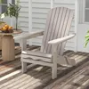 An Adirondack chair sits on a wooden deck in front of a white clapboard wall. Podgląd zdjęcia produktu