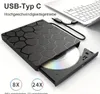 A black external DVD/CD drive with a honeycomb pattern is connected to a laptop via a USB-C cable. A DVD is partially inserted into the drive. Produktbild-Vorschau