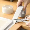 Hands using scissors to cut a roll of white sealing tape along a countertop and sink edge. Anteprima dell’immagine prodotto