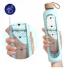 A hand holding a light blue water bottle with time markers and water level indicators. A close-up inset shows the water level and markers. Náhľad obrázku produktu