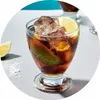A close-up shot of a cola drink in a glass with ice and lime. Produktbild-Vorschau