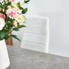 A close-up shot of a white chair and flowers on a table. Voir les images du produit