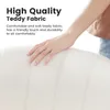 A hand touching a white, textured fabric, likely part of a chair or sofa, with marketing text overlayed. Voir les images du produit