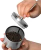 A hand is holding a lid of a tea infuser, and another hand is holding the infuser which is filled with tea leaves. Podgląd zdjęcia produktu