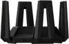 A black Xiaomi Tri-Band Wireless Wi-Fi 6 Router is shown from a front-side angle against a black background. Náhled obrázku produktu