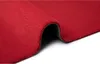 A close-up, angled view of a red rug, with a portion rolled back to show the underside. Produktbild-Vorschau