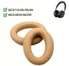 A pair of khaki-colored ear pads for headphones are shown in the foreground, with a black pair of headphones in the upper right corner. Text indicating compatibility is present in the upper left corner. Produktbild-Vorschau