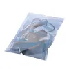 A product is shown inside a clear plastic bag with a blue and white design. Náhled obrázku produktu