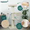 A cream-colored cat tree with multiple levels and scratching posts, set in a room with a plant and furniture. The image includes callouts highlighting features. Podgląd zdjęcia produktu