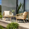 A rattan lounge set with two chairs and a coffee table on a wooden deck. Náhled obrázku produktu