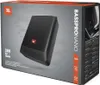 The image shows the retail packaging of a JBL Bass Pro Nano subwoofer. The box is predominantly gray with black accents and features an image of the product itself. Voir les images du produit